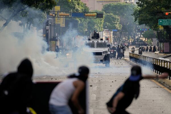 FILE - Protesters clash with police during demonstrations against the official election results declaring President Nicolas Maduro's reelection, the day after the vote in Caracas, Venezuela, July 29, 2024. (AP Photo/Matias Delacroix, File)