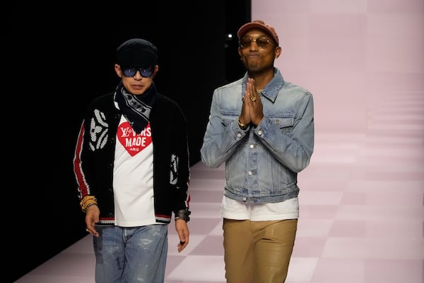 Pharrell Williams, right, walks with with Nigo, artistic designer for Kenzo, with who co-creates a collection, after the men's Louis Vuitton Fall-Winter 2025-2026 collection, that was presented in Paris, Tuesday, Jan. 21, 2025. (AP Photo/Michel Euler)