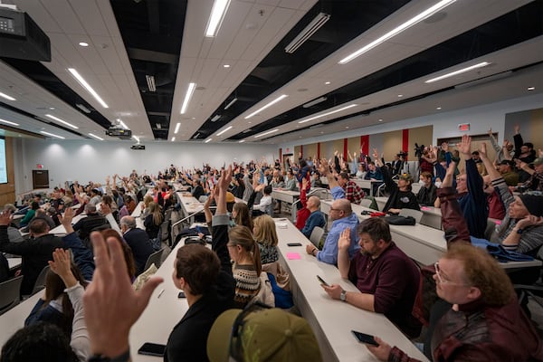 Concerned citizens raise their hands during a GOP town hall meeting with Reps. Celeste Malloy and Mike Kennedy, R-Utah, Thursday, March 20, 2025, in Salt Lake City. (AP Photo/Rick Egan)