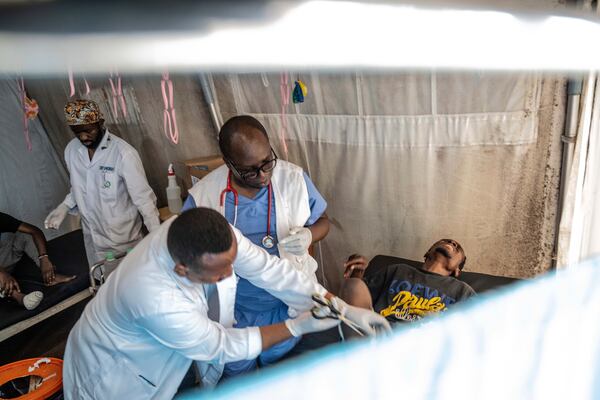 Medics treat a man wounded during fighting between Congolese government troops and M23 rebel forces in Goma's Kyeshero hospital Saturday, Feb. 1, 2025. (AP Photo/Moses Sawasawa)