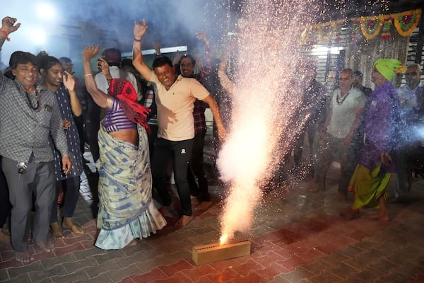 Villagers light fire crackers and dance as they celebrate the safe return of NASA astronaut Suni Williams from the International Space Station (ISS), at a temple in her ancestral village Jhulasan in Mehsana district of Gujarat state, India, Wednesday, March 19, 2025. (AP Photo/Ajit Solanki)