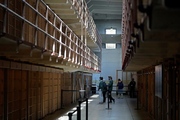 FILE - People tour the main cell house on Alcatraz Island in San Francisco, March 15, 2021, as the historic island prison was reopened to visitors after being closed since Dec. 2020, because of the coronavirus threat. (AP Photo/Eric Risberg, File)
