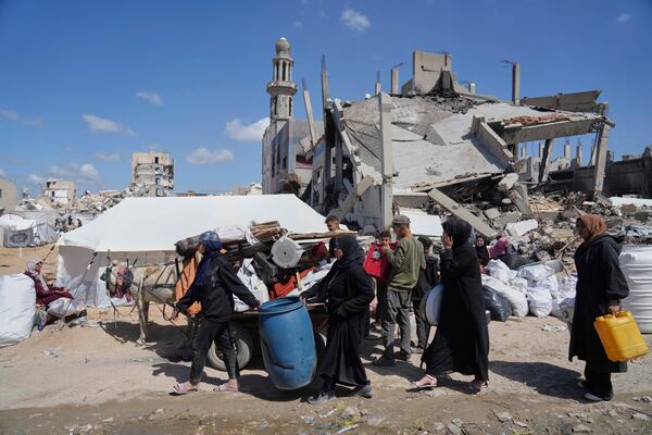 Displaced Palestinians, carrying their belongings traveling from Beit Hanoun to Jabaliya, a day after Israel's renewed offensive in the Gaza Strip, Wednesday, March 19, 2025. (AP Photo/Jehad Alshrafi)