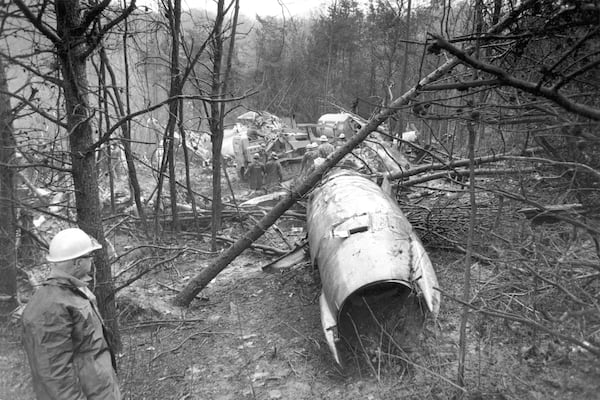 FILE - In this Nov. 15, 1970, file photo, a fireman looks over the wreckage of a plane in Kenova near Huntington, W.Va., that killed all 75 aboard including members of the Marshall football team. (AP Photo/Henry Griffin, File)