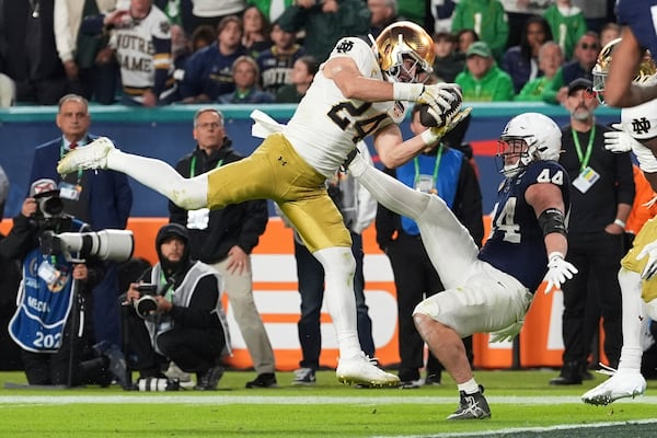 Notre Dame linebacker Jack Kiser (24) grabs a pass in front of Penn State tight end Tyler Warren (44) during the second half of the Orange Bowl College Football Playoff semifinal game, Thursday, Jan. 9, 2025, in Miami Gardens, Fla. (AP Photo/Rebecca Blackwell)