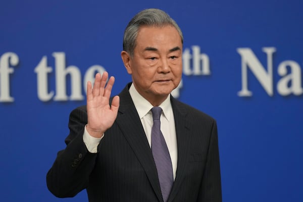 Chinese Foreign Minister Wang Yi arrives for a press conference on the sideline of the National People's Congress in Beijing, Friday, March 7, 2025. (AP Photo/Ng Han Guan)