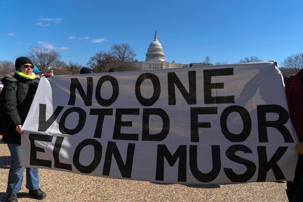 People take part in the "No Kings Day" protest on Presidents Day in Washington, in support of federal workers and against recent actions by President Donald Trump and Elon Musk, Monday, Feb. 17, 2025, by the Capitol in Washington. The protest was organized by the 50501 Movement, which stands for 50 Protests 50 States 1 Movement. (AP Photo/Jose Luis Magana)