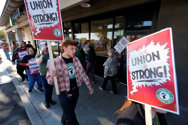 Starbuck workers picket outside of a closed Starbucks on Friday, Dec. 20, 2024, in Burbank, Calif. (AP Photo/Damian Dovarganes)