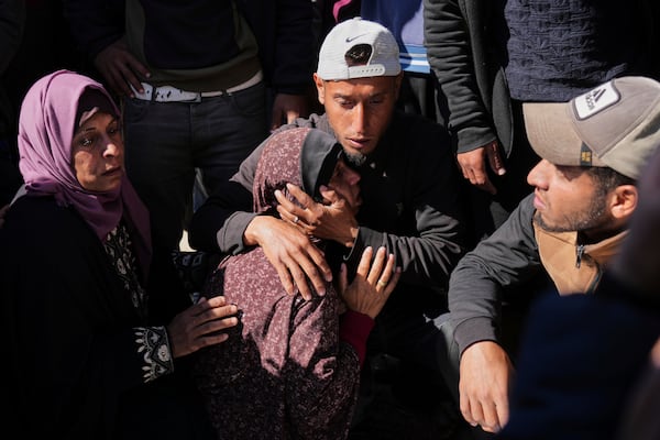 Mourners react during the funeral of Palestinians killed in the Israeli bombardment of the Gaza Strip at Nasser Hospital in Khan Younis, Sunday, March 23, 2025. (AP Photo/Abdel Kareem Hana)