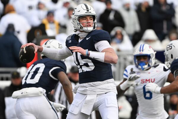 Penn State quarterback Drew Allar (15) throws a pass while being pressured by SMU defensive end Jahfari Harvey (6) during the first half in the first round of the NCAA College Football Playoff, Saturday, Dec. 21, 2024, in State College, Pa. (AP Photo/Barry Reeger)