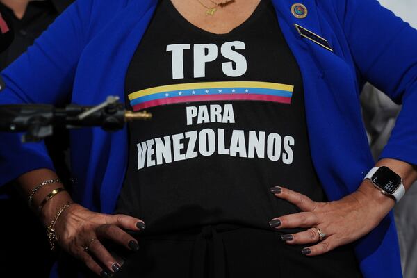 Activist Helene Villalonga wears a tee-shirt calling for Temporary Protected Status for Venezuelans during a press conference to denounce changes to the protections that shielded hundreds of thousands of Venezuelans from deportation, Monday, Feb. 3, 2025, in Doral, Fla. (AP Photo/Rebecca Blackwell)