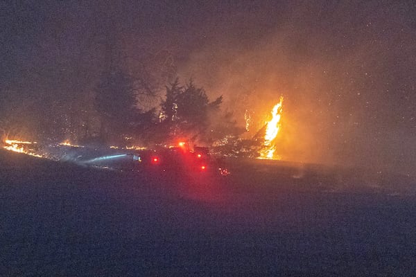 Fire crews from Coyle, Okla., battle a wildfire as it burns Friday, March 14, 2025, south of Langston, Okla. (AP Photo/Alonzo Adams)