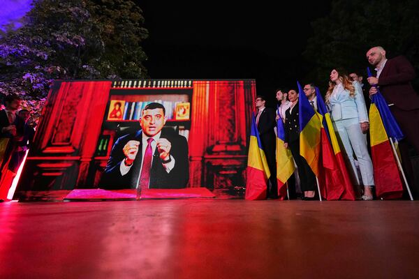 Presidential candidate George Simion addresses supporters via video link after polls closed for the first round of the country's presidential election redo in Bucharest, Romania, Sunday, May 4, 2025. (AP Photo/Andreea Alexandru)