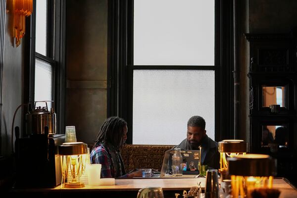 Patrons sit at tables near the bar of Columns Hotel on St. Charles Ave., in New Orleans, Friday, Jan. 24, 2025. (AP Photo/Gerald Herbert)