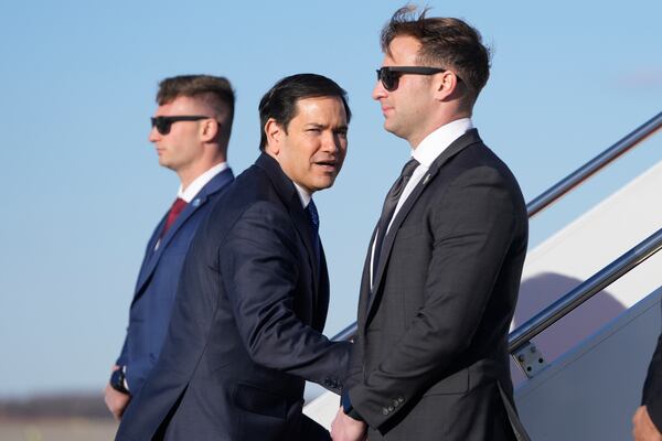 Secretary of State Marco Rubio, center, boards a plane Saturday, Feb. 1, 2025, at Joint Base Andrews, Md., en route to Panama. (AP Photo/Mark Schiefelbein, Pool)