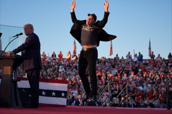 FILE - Elon Musk jumps on the stage as Republican presidential nominee former President Donald Trump speaks at a campaign rally at the Butler Farm Show, Oct. 5, 2024, in Butler, Pa. (AP Photo/Evan Vucci, File)