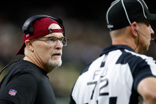 Washington Commanders head coach Dan Quinn talks to a referee in the second half of an NFL football game against the New Orleans Saints in New Orleans, Sunday, Dec. 15, 2024. (AP Photo/Butch Dill)