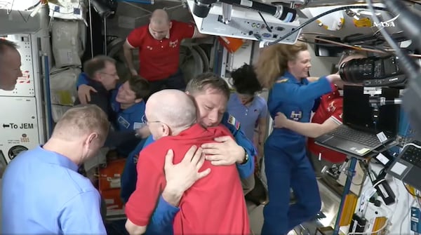 This image made from video by NASA shows astronauts Don Pettit, bottom center, hugging Kirill Peskov as astronauts greet each other after the SpaceX capsule docked with the International Space Station, Sunday, March 16, 2025. (NASA via AP)