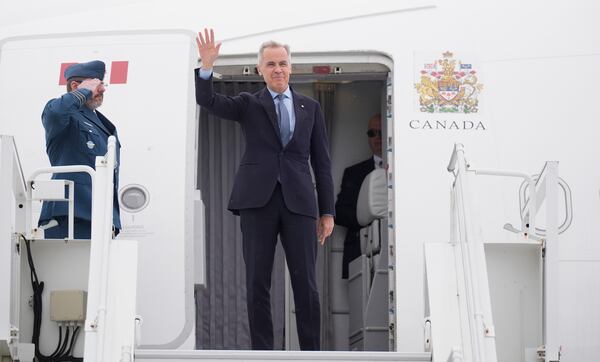 Canadian Prime Minister Mark Carney boards a government plane in Ottawa, Ontario, Monday, May 5, 2025, en route to Washington for a meeting with U.S. President Donald Trump on Tuesday. (Adrian Wyld/The Canadian Press via AP)