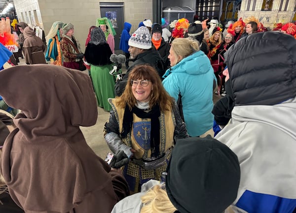 Antoinette de Alteriis, co-captain of the Krewe de Jeanne d'Arc, organizes volunteers before the start of the Joan of Arc parade on Monday, Jan. 6, 2025, in New Orleans. (AP Photo/Jack Brook)