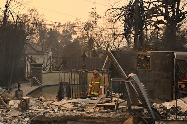 Robert Lara looks through his home that was destroyed after the Eaton Fire burns in Altadena, Calif., Thursday, Jan. 9, 2025. (AP Photo/Nic Coury)