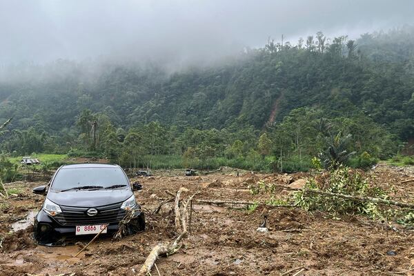 The wreckage of a car is stuck in the mud at an area affected by a landslide following a flash flood which killed a number of people in Pekalongan, Central Java, Indonesia, Wednesday, Jan. 22, 2025. (AP Photo/Janaki DM)