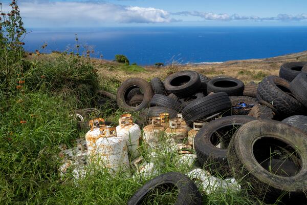 Propane tanks and discarded tires are temporarily stored at Kahikinui homestead on Sunday, July 7, 2024, in Kahikinui, Hawaii. Residents were asked to remove unused items to reduce fire risks. (AP Photo/Mengshin Lin)