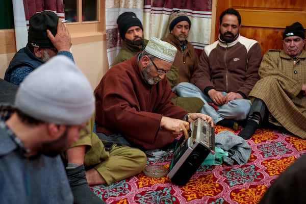 A Kashmiri man checks his tape recorder before the start of the Sufi gathering in the outskirts of Srinagar, Indian controlled Kashmir, Thursday, Feb. 13, 2025. (AP Photo/Dar Yasin)