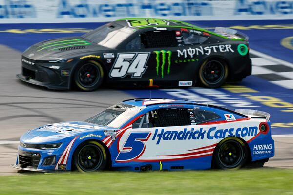 Kyle Larson (5) laps Ty Gibbs (54) during a NASCAR Cup Series auto race at Kansas Speedway in Kansas City, Kan., Sunday, May 11, 2025. (AP Photo/Colin E. Braley)