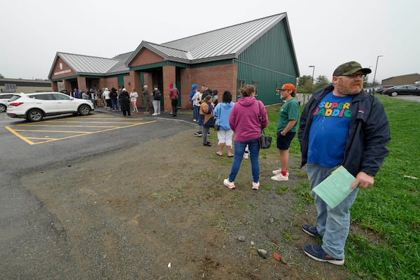 Matthew Nason of Vassalboro, Maine, who needed to file forms for his motorcycle, waits at the end of a long line at the Bureau of Motor Vehicles where many residents are applying for Real ID, Wednesday, May 7, 2025, in Augusta, Maine. (AP Photo/Robert F. Bukaty)