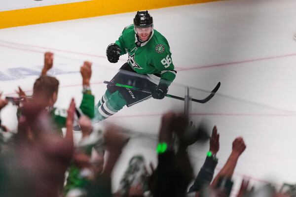 Fans and Dallas Stars' Mikko Rantanen, celebrate after Rantanen scored an emtpy-net goal against the Colorado Avalanche in the third period in Game 7 of a first-round NHL hockey playoff series Saturday, May 3, 2025, in Dallas. (AP Photo/Julio Cortez)