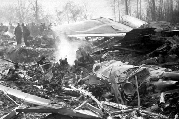 FILE - The smoldering wreckage of a Sabena Boeing jet airliner that crashed near Brussels, Belgium, is shown Feb. 15, 1961 . The 17-member U.S. figure skating team and their coach were among the 72 persons aboard the plane who were killed. (AP Photo/File)