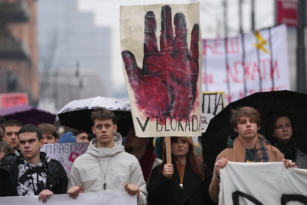 Students joined calls for a general strike and stopping traffic stand in silence to commemorate the 15 victims killed after a railway concrete canopy fell in November, to demand accountability for the tragedy in Belgrade, Serbia, Friday, Jan. 24, 2025. (AP Photo/Darko Vojinovic)