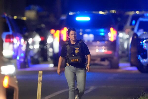 A Louisiana state police member works the scene on North Galvez Street as law enforcement pursue a fugitive that escaped from a New Orleans jail, Tuesday, May 20, 2025, in New Orleans. (AP Photo/Gerald Herbert)