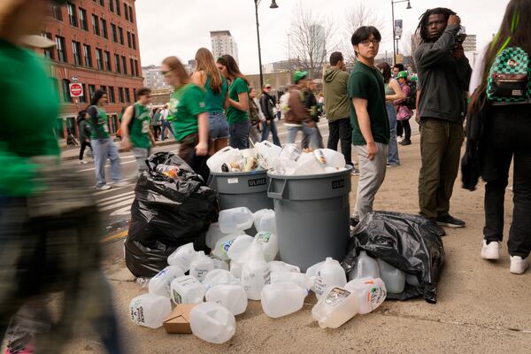 Empty containers used for homemade drinks overflow the garbage cans after the St. Patrick's Day parade, Sunday, March 16, 2025, in Boston, Mass. (AP Photo/Robert F. Bukaty)