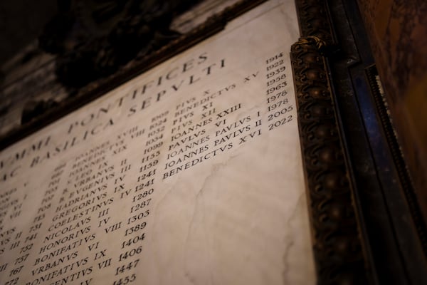 The names of the Roman Catholic popes who have been buried in St. Peter's Basilica at The Vatican are engraved on a memorial stone inside the Vatican Basilica, Friday, Feb. 28, 2025. (AP Photo/Bernat Armangue)