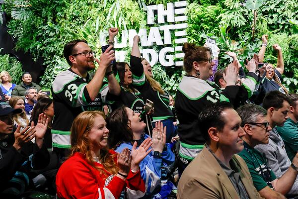Fans stand and cheer as the newest PWHL team is announced for Seattle during a press conference at Climate Pledge Arena, Wednesday, April 30, 2025, in Seattle. (Jennifer Buchanan/The Seattle Times via AP)