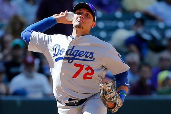 FILE - Los Angeles Dodgers shortstop Miguel Rojas throws to first during the inning of a baseball game against the Colorado Rockies, Sept. 17, 2014, in Denver. (AP Photo/Jack Dempsey, FIle)