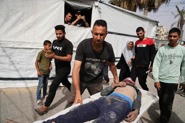 A Palestinian man killed in an Israeli airstrike on central Gaza Strip is brought to Al-Aqsa Hospital in Deir al-Balah, on Saturday, May 17, 2025. (AP Photo/Abdel Kareem Hana)