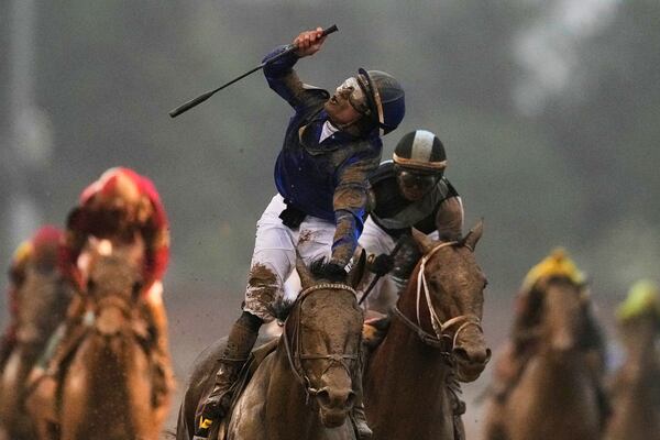 Jockey Junior Alvarado celebrates after riding Sovereignty to victory in the 151st running of the Kentucky Derby horse race at Churchill Downs Saturday, May 3, 2025, in Louisville, Ky. (AP Photo/Brynn Anderson)