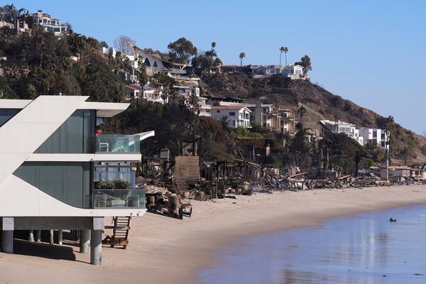 A home stands next to properties destroyed by the Palisades Fire in Malibu, Calif., Sunday, Jan. 12, 2025. (AP Photo/Mark J. Terrill)