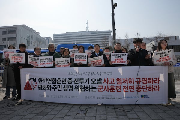 Protesters attend a press conference demanding to stop the upcoming Freedom Shield military exercise between the U.S. and South Korea and also demanding to investigate the cause thoroughly about fighter jets accidentally dropped eight bombs on a civilian area, in Seoul, South Korea, Friday, March 7, 2025. A banner reads "Stop the Freedom Shield military exercise between the U.S. and South Korea and Demand to Investigate the cause thoroughly about fighter jets accidentally dropped eight bombs." (AP Photo/Lee Jin-man)