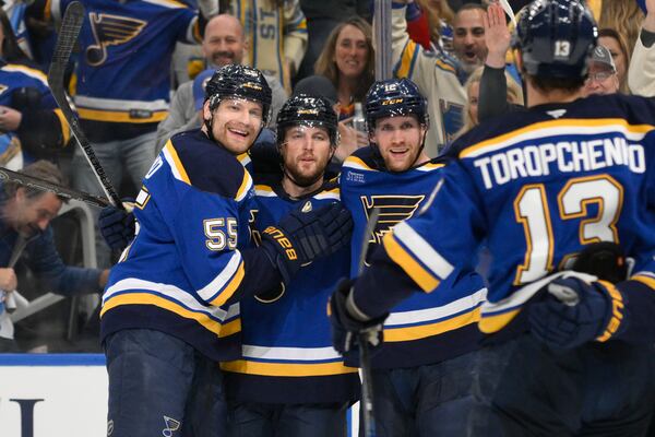 St. Louis Blues defenseman Cam Fowler (17) is congratulated by teammates after scoring against the Winnipeg Jets during the second period in Game 6 of an NHL hockey first-round playoff series Friday, May 2, 2025, in St. Louis. (AP Photo/Jeff L)