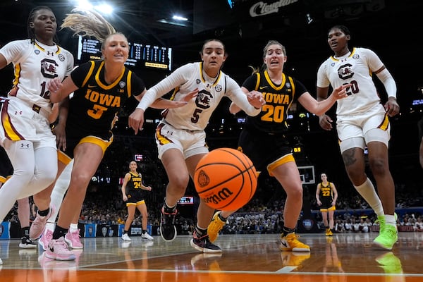 FILE - South Carolina guard Tessa Johnson (5) fights for a loose ball with Iowa guard Sydney Affolter (3) and guard Kate Martin (20) during the second half of the Final Four college basketball championship game in the women's NCAA Tournament, Sunday, April 7, 2024, in Cleveland. (AP Photo/Morry Gash, File)