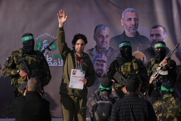 Israeli Ofer Kalderon who has been held hostage by Hamas in Gaza since October 7, 2023, waves before being handed over to the Red Cross by Hamas fighters in Khan Younis, southern Gaza Strip, Saturday Feb. 1, 2025. Photo/Abdel Kareem)