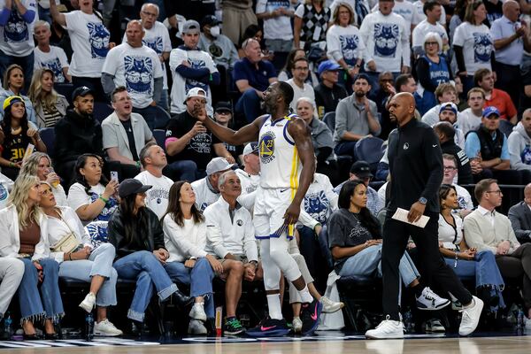 Golden State Warriors forward Draymond Green (23) reacts to the crowd during the first half of Game 2 of an NBA basketball second-round playoff series against the Minnesota Timberwolves, Thursday, May 8, 2025, in Minneapolis. (Carlos Avila Gonzalez/San Francisco Chronicle via AP)