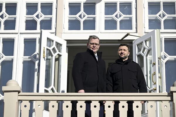 Finland's Prime Minister Petteri Orpo, left and visiting Ukrainian President Volodymyr Zelenskyy stand on the balcony of the Prime Minister's official residence Kes'ranta in Helsinki, Finland, Wednesday, March 19, 2025. (Heikki Saukkomaa/Lehtikuva via AP)