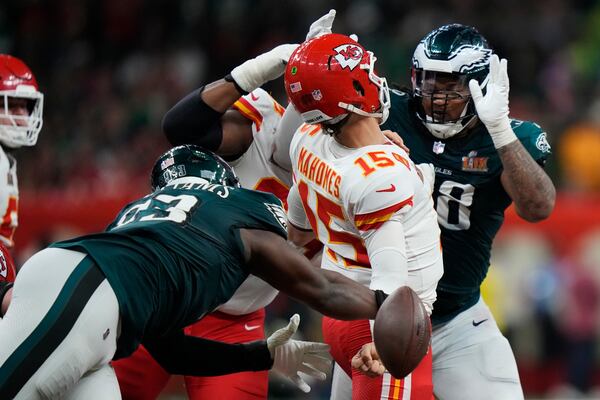 Philadelphia Eagles defensive tackle Milton Williams (93) strips the ball from Kansas City Chiefs quarterback Patrick Mahomes(15) during the second half of the NFL Super Bowl 59 football game, Sunday, Feb. 9, 2025, in New Orleans. (AP Photo/Frank Franklin II)