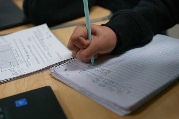 A student writes math problems in a fourth grade classroom at William Jefferson Clinton Elementary in Compton, Calif., Thursday, Feb. 6, 2025. (AP Photo/Eric Thayer)