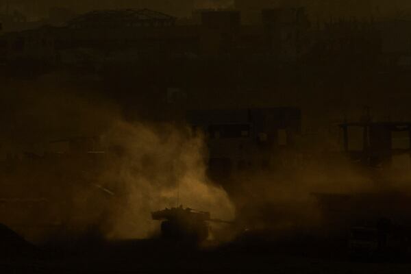 An Israeli army tank maneuvers in the Gaza Strip is seen from southern Israel, Sunday, May 4, 2025. (AP Photo/Ariel Schalit)